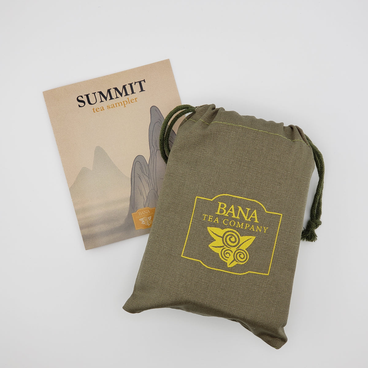 An olive green drawstring pouch with a yellow Bana Tea Company logo, shown next to a beige paper insert card labeled Summit Tea Sampler on a light gray background.