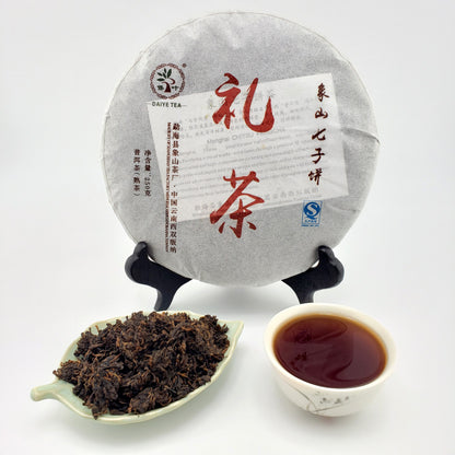 Tea cake with text, a cup of tea, and tea leaves on a white background