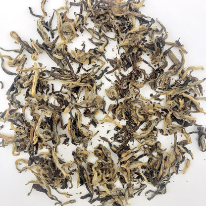 Dry tea leaves on a white background