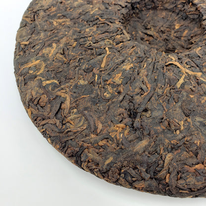Close-up of a compressed tea cake on a white background