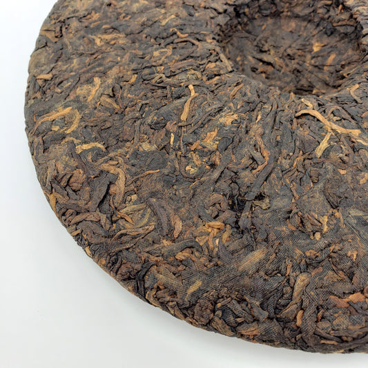 Close-up of a compressed tea cake on a white background
