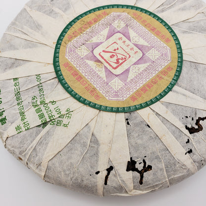 Round tea cake with a colorful label on a white background