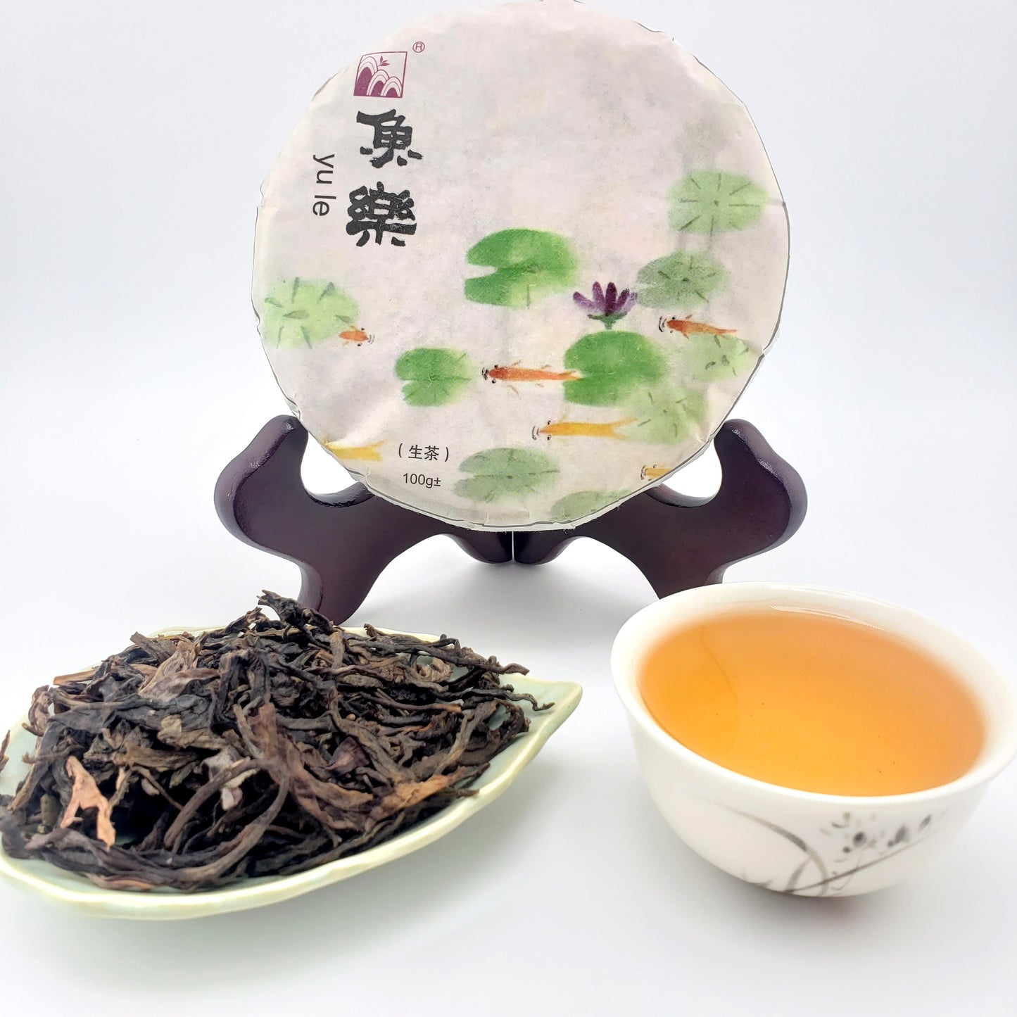 Tea packaging with a tea leaf display and a cup of tea on a white background