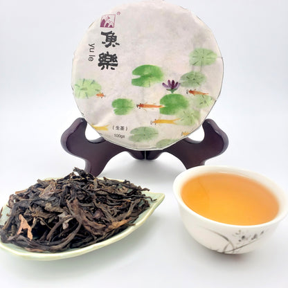 Tea packaging with a tea leaf display and a cup of tea on a white background