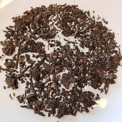 Dry pu-erh tea leaves on a white background
