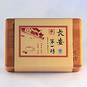 Wooden tea box with decorative label on a white background