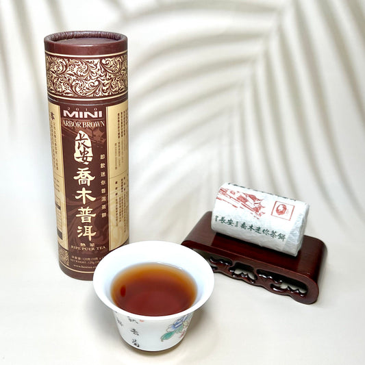 Tea packaging and cup with tea on a white background