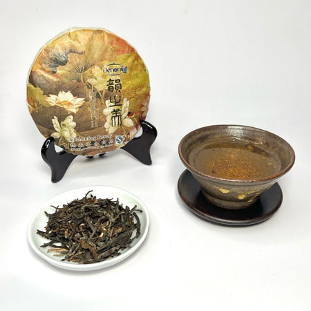 Tea cake, loose tea leaves, and a teacup on a white background