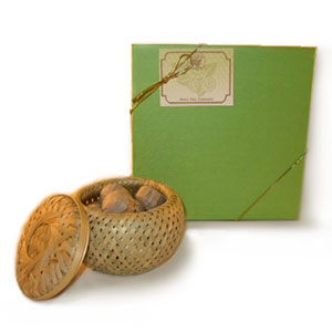 Woven basket with small items on a green box with a label