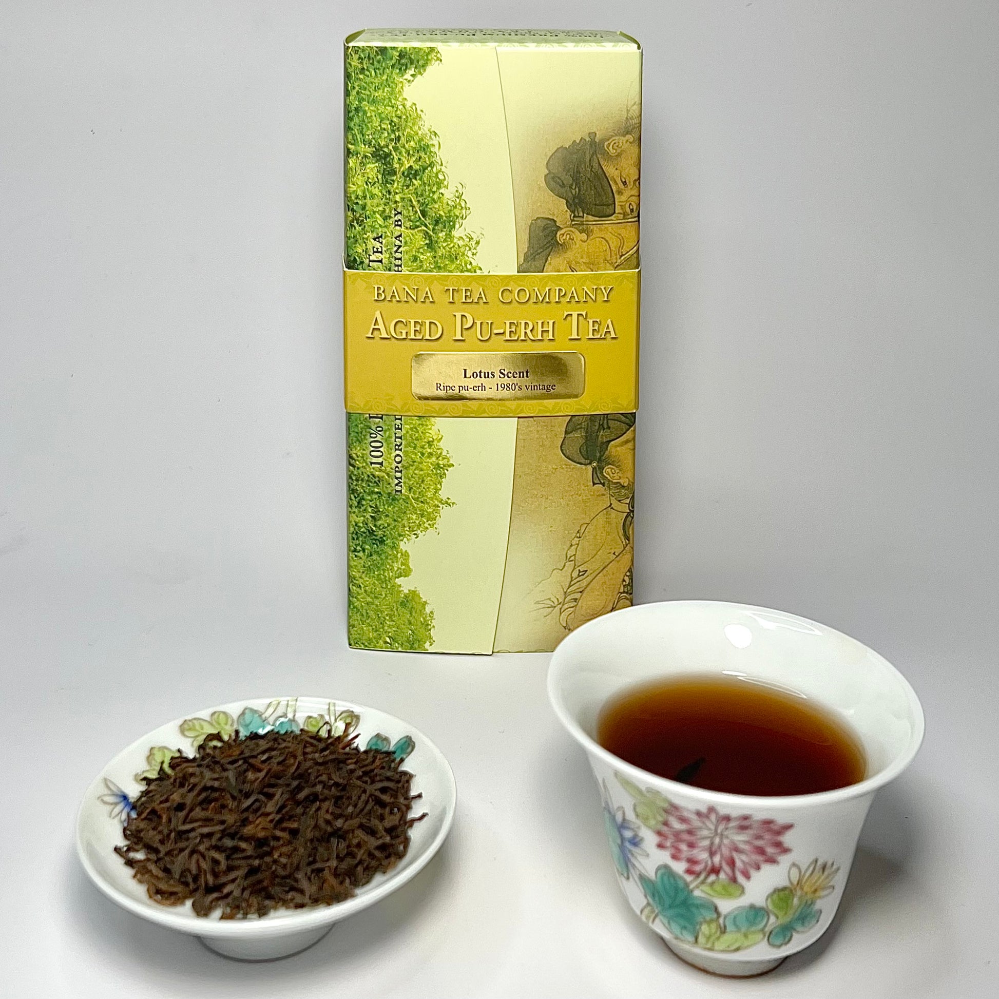 Bana Tea Company Aged Pu-erh tea packaging with a cup of tea and tea leaves on a white background