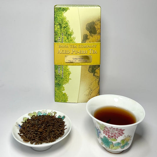 Bana Tea Company Aged Pu-erh tea packaging with a cup of tea and tea leaves on a white background