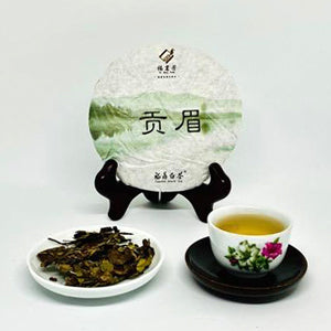 Tea packaging with a cup of tea and tea leaves on a white background