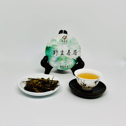 Tea packaging, tea leaves, and a cup of tea on a white background