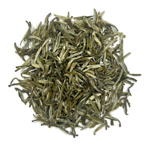 Green tea leaves on a white background