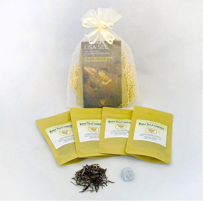 Tea packaging set with yellow bags and a clear bag containing tea leaves on a white background