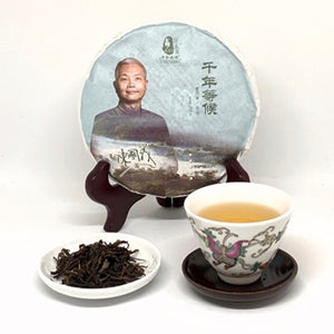 Tea packaging with a person, tea leaves, and a teacup on a white background