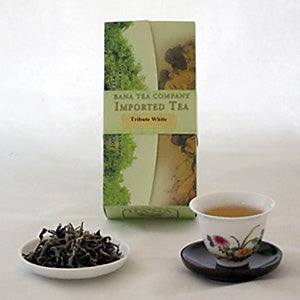 Tea packaging, tea leaves, and a cup of tea on a white background