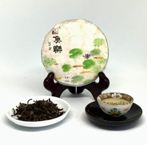 Tea cake, tea leaves, and a teacup on a white background